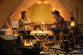 Asian couple enjoy in they tent in camping trip on night time Royalty Free Stock Photo