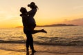 Asian couple expressing their feeling while standing at beach, Young couples hug at the sea at sunset