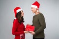 Asian couple giving each other christmas gifts Royalty Free Stock Photo