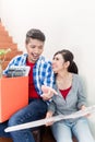 Asian couple with ground plot planning arrangement of new apartm Royalty Free Stock Photo