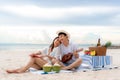 Asian couple happy and enjoy the trip honeymoon of couple lover on the sea beach by playing Ukulele and singing song music Royalty Free Stock Photo