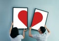 Asian couple holding heat in picture frames. Royalty Free Stock Photo
