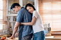 Asian couple in the kitchen, Attractive wife is embracing husband