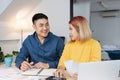 Asian couple list home financial bill budget on table in kitchen at new house.family expense