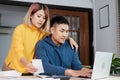 Asian couple list home financial bill budget on table in kitchen at new house.family expense