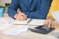 Asian couple list home financial bill budget on table in kitchen at new house.family expense