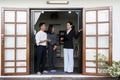 Asian couple looking at house plans and talking with a real estate agent about signing documents for purchase of a new Royalty Free Stock Photo