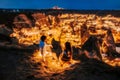 Asian Couple in love and looking night view of Uchisar Goreme sunset view point ,Cappadocia. Nevsehir Province Turkey. This