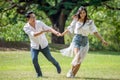 asian couple in love running in park having happiness and joy