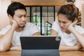 Asian couple lover in cafe get confused with application in the tablet computer Royalty Free Stock Photo