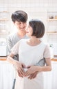 Asian couple making heart shape with their hands on pregnant belly,.Pregnant Woman and Husband holding hands in heart shape on Royalty Free Stock Photo