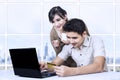 Asian couple paying online in office using credit card Royalty Free Stock Photo