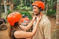 asian couple put on each others savety helmet before riding an atv Royalty Free Stock Photo