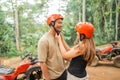 asian couple put on each others savety helmet before riding the atv Royalty Free Stock Photo