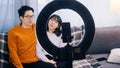 Asian couple, recording video with phone camera. Influencers streaming on social media