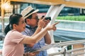 Asian couple retirement age, tourists are happy With photography Various tourist attractions By looking at the map