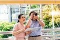 Asian couple retirement age, tourists are happy With photography Various tourist attractions By looking at the map