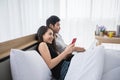 Asian Couple shopping online and paying with credit card on laptop and mobile phone at home,Happy couple at home surfing the net Royalty Free Stock Photo