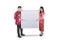 Asian couple showing a blank whiteboard on studio Royalty Free Stock Photo