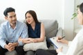 Asian couple sitting on the couch in the room to consult mental health problems by doctor, Health and illness concepts