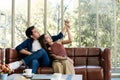 An asian couple sitting in living room