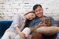 Asian couple sitting sofa using cell smart phone Royalty Free Stock Photo