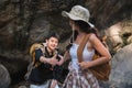 An Asian couple spent their vacation hiking along nature trail, visiting waterfall and enjoying forest views together. Royalty Free Stock Photo