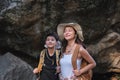 An Asian couple spent their vacation hiking along nature trail, visiting waterfall and enjoying forest views together. Royalty Free Stock Photo