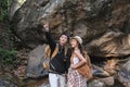 An Asian couple spent their vacation hiking along nature trail, visiting waterfall and enjoying forest views together. Royalty Free Stock Photo