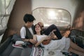 Asian couple sweet in tent inside on they camping trip, traveller relax and sleep togather