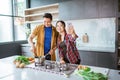 asian couple taking selfie while cooking together in the kitchen Royalty Free Stock Photo