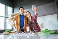 asian couple taking selfie while cooking together in the kitchen Royalty Free Stock Photo