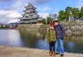 Asian couple tourist embracing at Matsumoto Castle