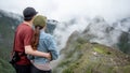 Asian couple tourist looking at Machu Picchu