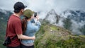 Asian couple tourist taking photo of Machu Picchu