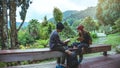 Asian couple travel photograph nature education. nature relax and study read a book. at public park. In Thailand Royalty Free Stock Photo