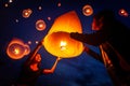 Asian couple traveller setting yi peng lantern in loi krathong festivities