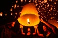 Asian couple traveller setting yi peng lantern in loi krathong festivities