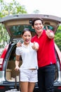 Asian couple travelling with new car Royalty Free Stock Photo
