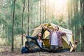 Asian couple wake up while camping in forest Royalty Free Stock Photo