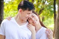 Asian couple wearing white shirts Happy smiling in the park. Family concept. Royalty Free Stock Photo