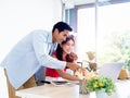 Asian couple, young woman and man looking and pointing at laptop computer screen on desk together. Royalty Free Stock Photo