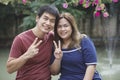 Asian couples hand sign victory with happy smiling face