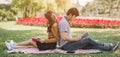 Asian couples reading a book .Campus life. Couple of students with a books. Education in nature park. Royalty Free Stock Photo