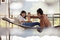 Asian couples relaxing vacation time on cradle Royalty Free Stock Photo