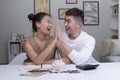 Asian Couples save money for future security. Lovers raise their hands to make hight five together after saving money successfully