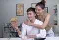 Asian couples save money to buy a new house. lovers save money for future security