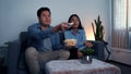 Asian couples watch movies on TV on weekends at night