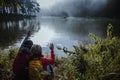 Asian couples are watching the swan, gracefully in a reservoir Pang Ung, Mae Hong Son, Thailand Royalty Free Stock Photo