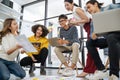Group of young happy Asian creative business people or hipster student using electronic devices tablet and laptop connection toget Royalty Free Stock Photo